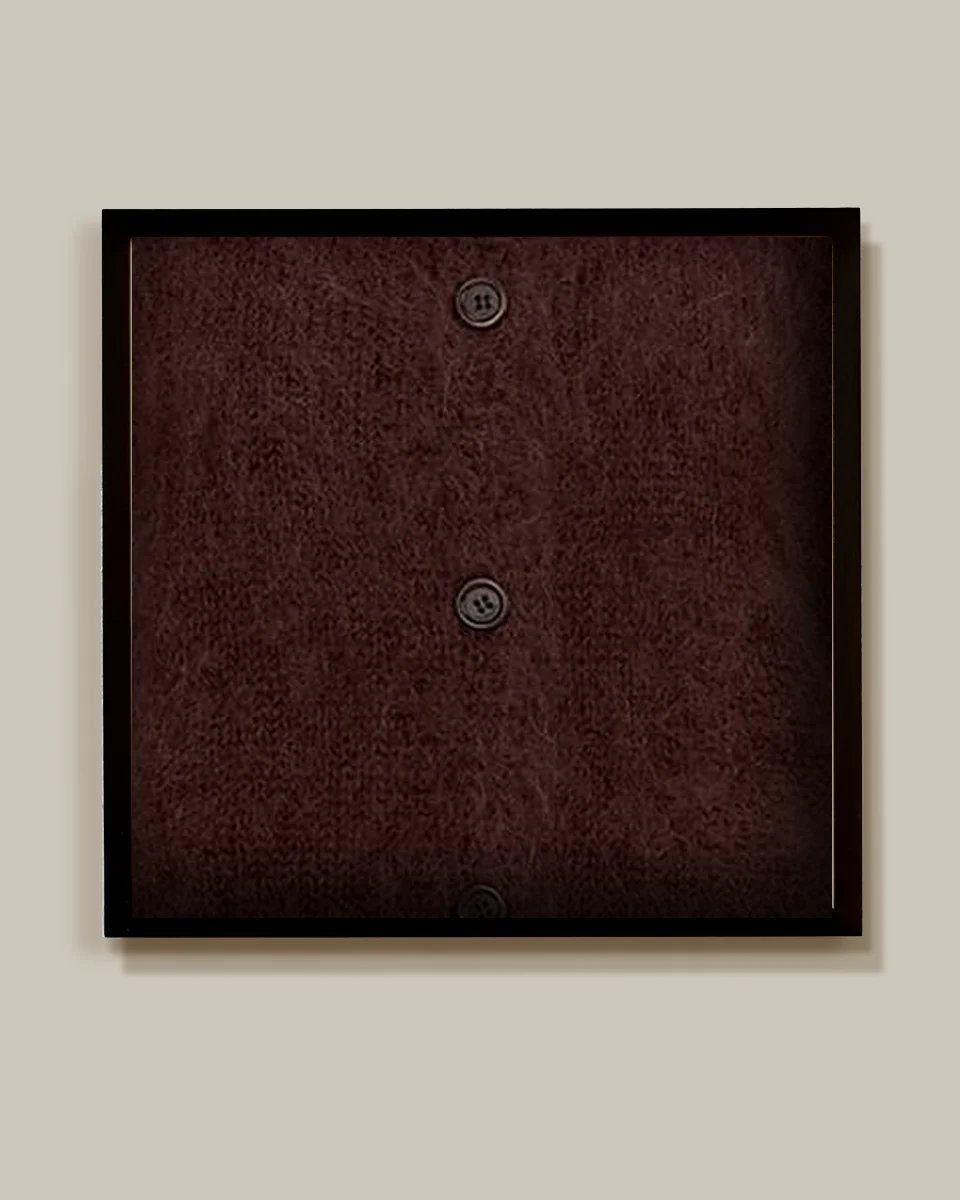 Brown mohair cardigan in a black shadow-box frame