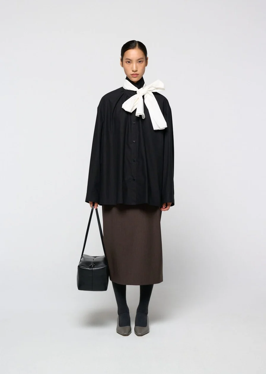 Product: Black blouse with white bow