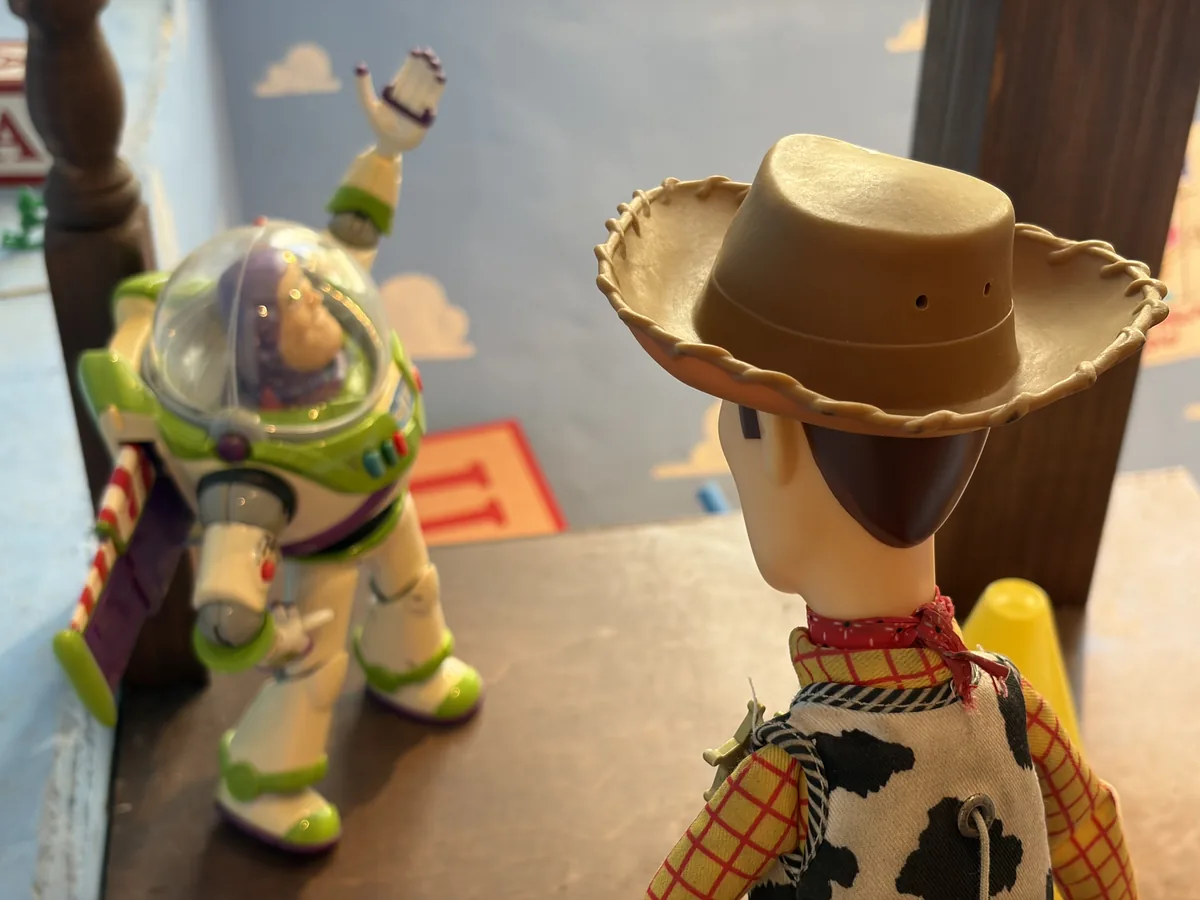 Buzz Lightyear and Woody figures on a shelf