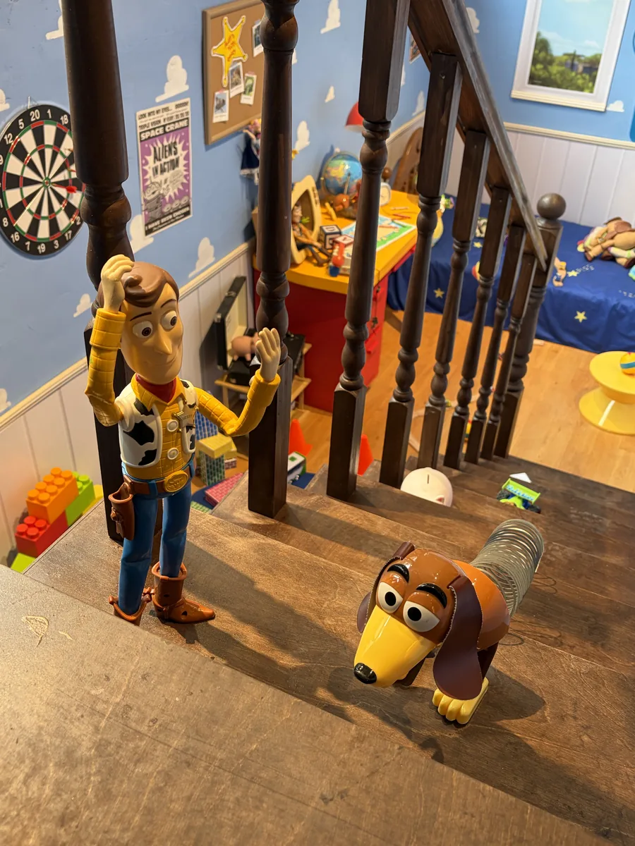 Woody on the stairs of the house set
